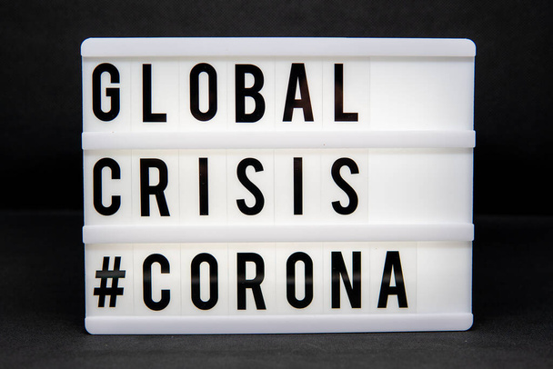 a light box with the inscription: GLOBAL CRISIS #CORONA with white background - Fotoğraf, Görsel
