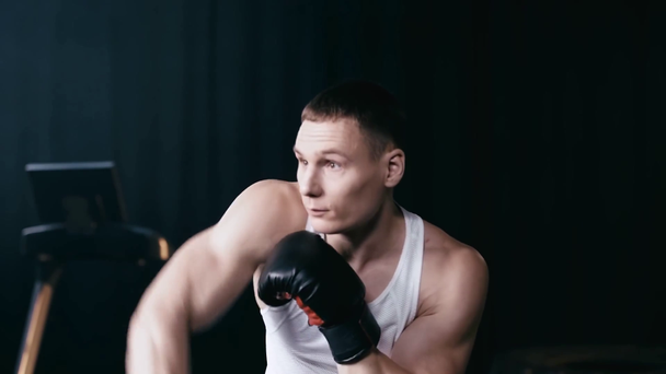Slow-motion of sportsman exercising with punching bag  - Кадри, відео