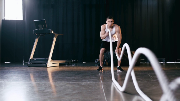 Lento movimiento del deportista ejercitándose con cuerdas de batalla
 - Metraje, vídeo