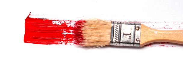 red streak of paint and brush. Valentine's day love. White background. copy space close up - Fotó, kép