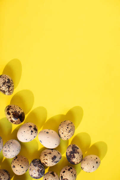 Flat lay. Bright yellow easter background with eggs. Text spase - 写真・画像