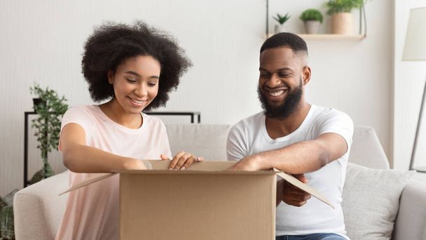 African american couple opens box from online store - Foto, Bild