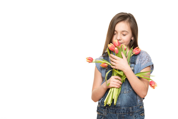 Adorable little girl holding bouquet of pink tulips against white background. Happy Mother's Day, Women's day, Father's day or Birthday concept. - Zdjęcie, obraz