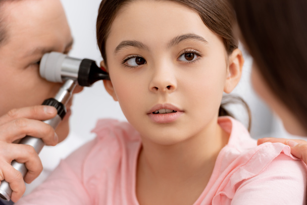 selective focus of ent physician examining ear of cute chid with otoscope - Photo, image