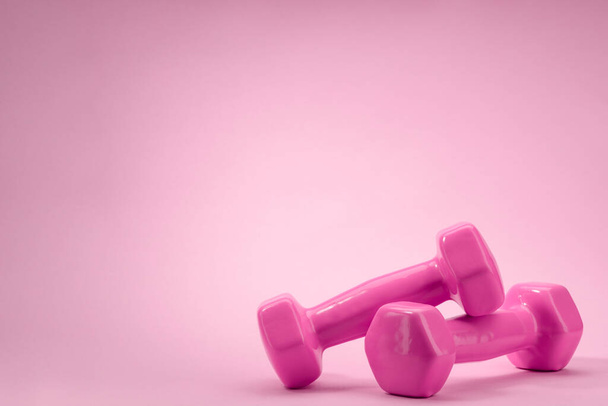 Dumbbells on pink background with copy space - Photo, Image