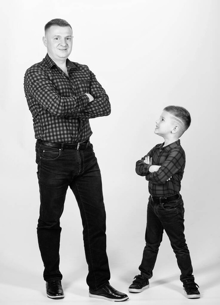 father and son in red checkered shirt. happy family. childhood. parenting. fathers day. little boy with dad man. Heating up the wild west. Bright memories. spend time together - Фото, изображение