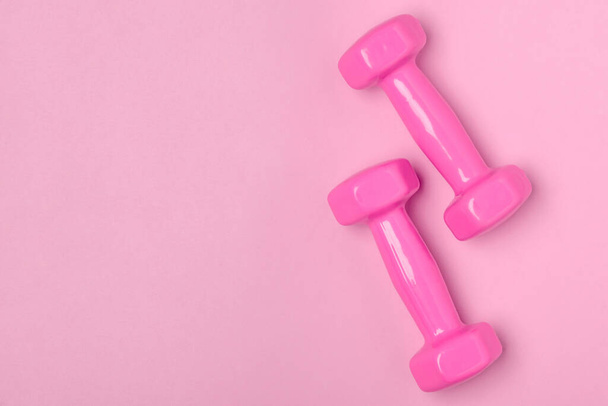 Top view on pink dumbbells with copy space - Фото, зображення