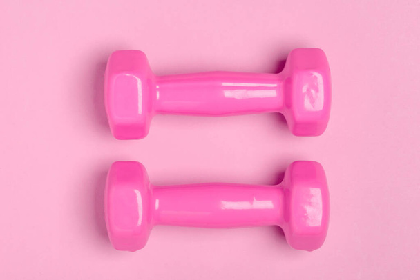 Top view on pink dumbbells. Equipment for fitness - Foto, Imagen
