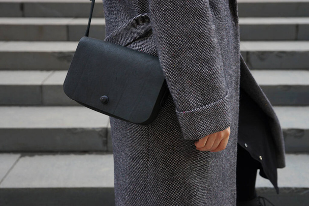 Woman with a small black bag over her shoulder - Fotó, kép