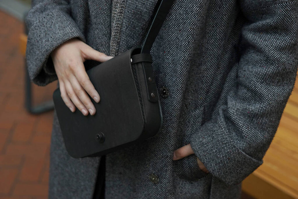 Nő egy kis fekete táskával a vállán - Fotó, kép