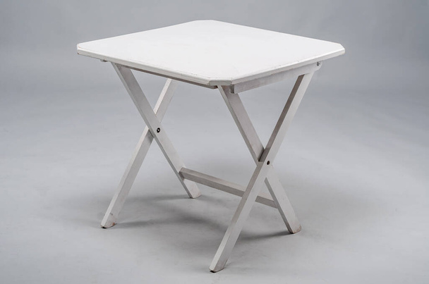 Λευκό ξύλινο πτυσσόμενο τραπέζι πάνω από λευκό φόντο. - Φωτογραφία, εικόνα