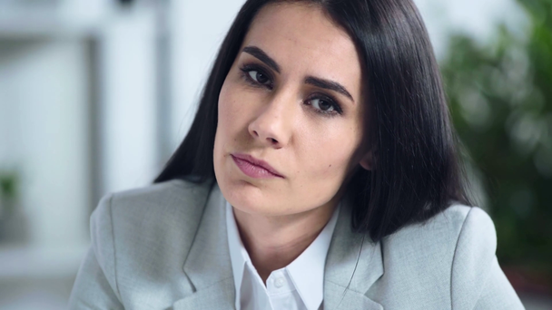 displeased businesswoman looking at camera in office  - Video
