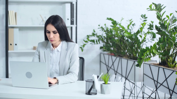 dissatisfied businesswoman using laptop in office  - Video, Çekim