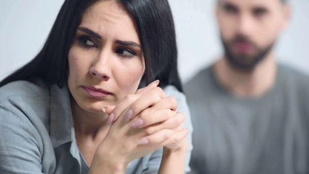 selective focus of woman sitting near displeased boyfriend  - Metraje, vídeo