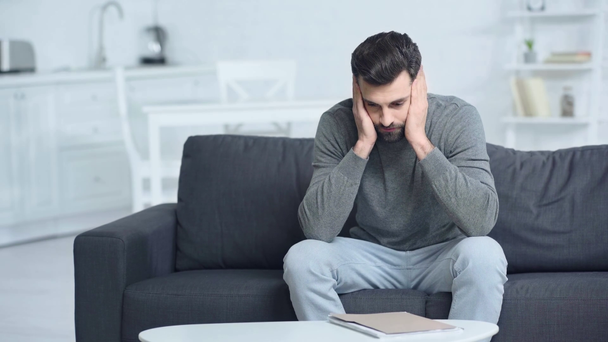 stressed man with folder touching head at home  - Footage, Video
