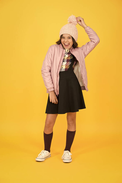 Best free time. beauty fashion for kid. back to school. ready for winter vacation. cosy autumn clothes. get knowledge of style. pleasant smile of little schoolgirl. cheerful child yellow background - 写真・画像