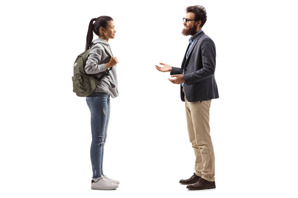 Full length profile shot of a female student and a bearded man having a conversation isolated on white background - Foto, immagini