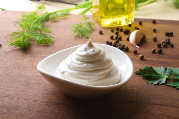 mayonnaise sour cream sauce on a wooden background cooking - Foto, Imagem