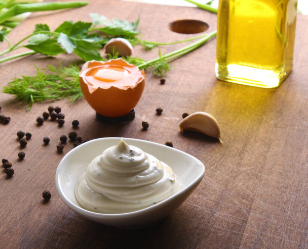 mayonnaise sour cream sauce on a wooden background cooking - Foto, Imagen