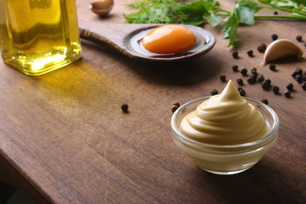 mayonnaise sour cream sauce on a wooden background cooking - 写真・画像