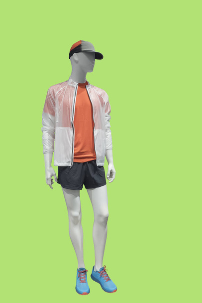 Full length male mannequin dressed in fashionable clothes, isolated on green background. No brand names or copyright objects. - Photo, Image