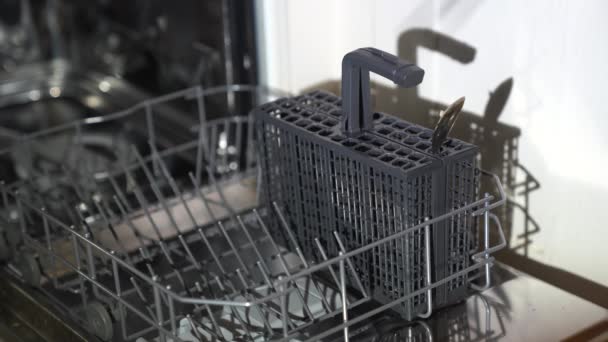 Women's hands make up the dishwasher, spoons and knives - Footage, Video