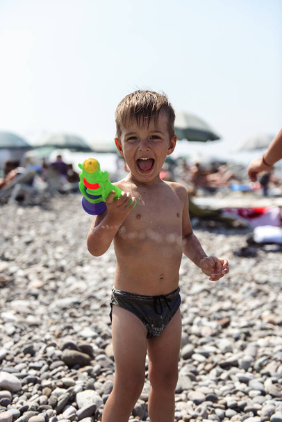 little boy with a toy on the beach - Фото, зображення