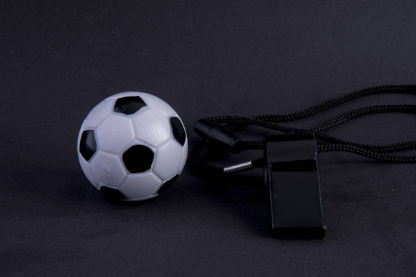 whistle with football on black background - Photo, Image
