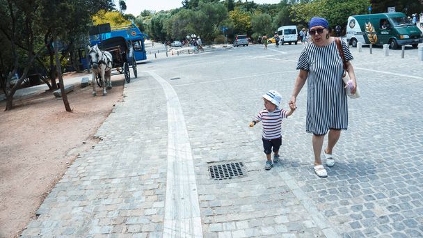 portrait of grandmother with grandson walking in park in Athens, Greece - Φωτογραφία, εικόνα