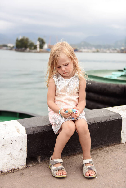 little girl with a backpack on the beach - Φωτογραφία, εικόνα