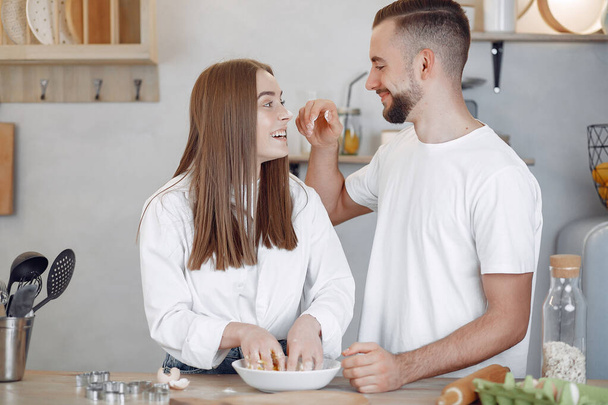 Beautiful couple prepare food in a kitchen - Foto, Imagen