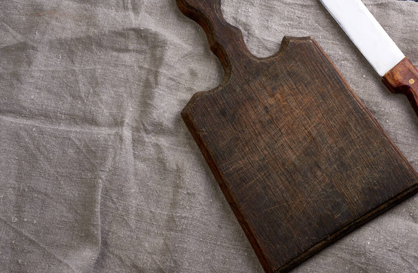 leeres braunes, sehr altes Küchenschneidebrett mit Griff, Draufsicht - Foto, Bild