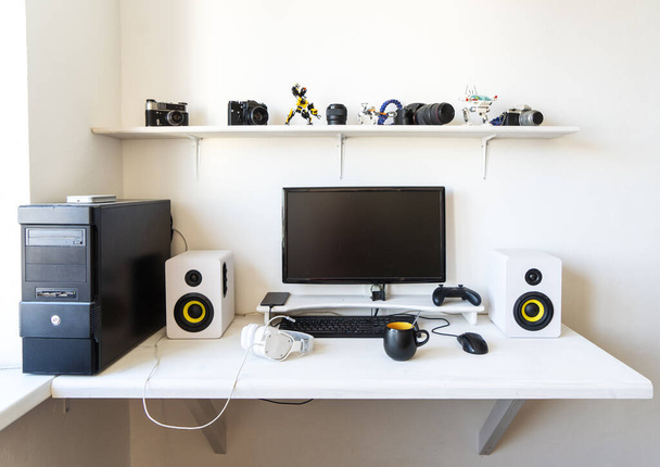 The workplace of a professional gamer with a monitor, gamepad, headphones and an armchair. - 写真・画像