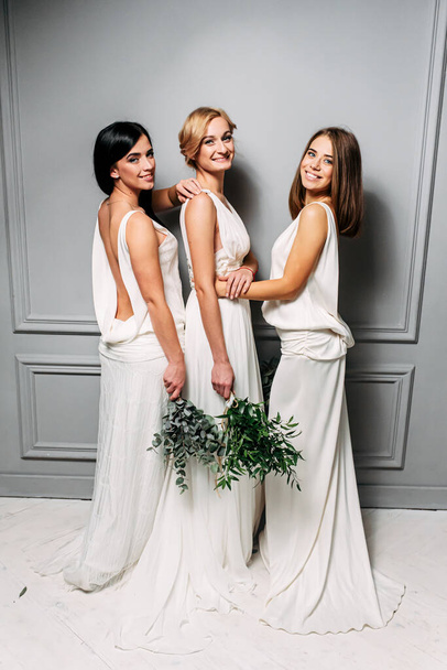 Bridesmaids in elegant white dresses in the studio - Foto, Imagem