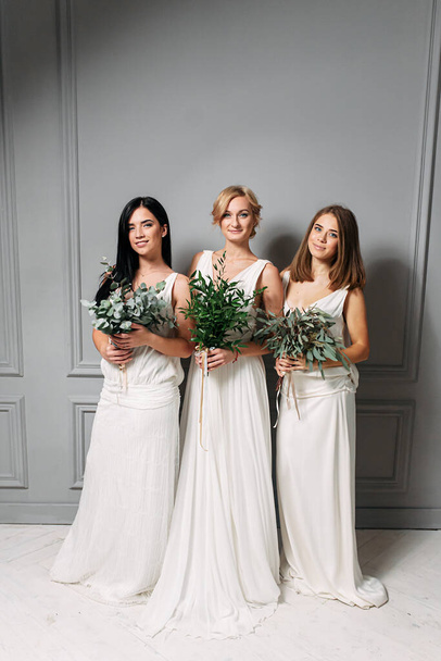 Bridesmaids in elegant white dresses in the studio - Фото, изображение