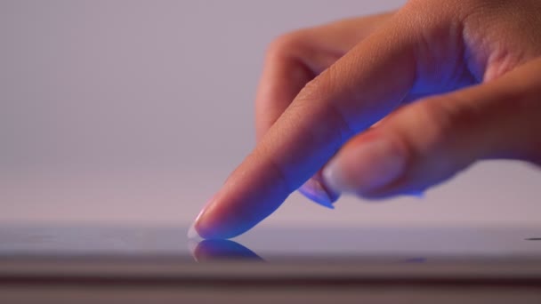 Close-up female hand using thin contemporary tablet pc or smartphone for surfing in internet - Footage, Video
