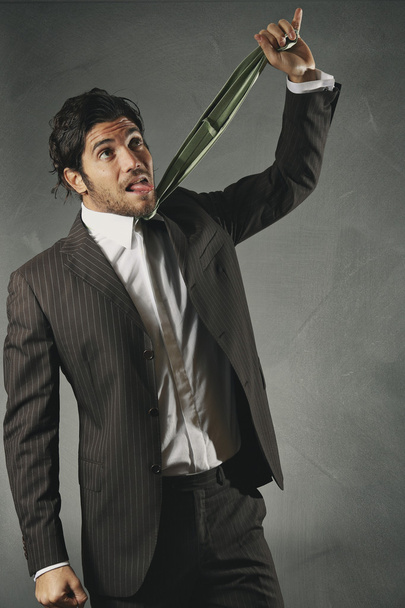 Worried businessman strangled by the tie - Photo, image