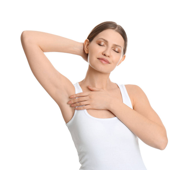 Young beautiful woman showing armpit with smooth clean skin on white background - Photo, image