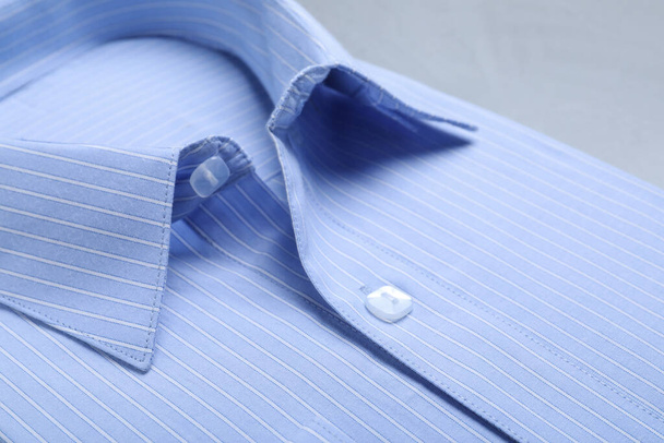 Closeup view of stylish light blue shirt. Dry-cleaning service - Fotoğraf, Görsel