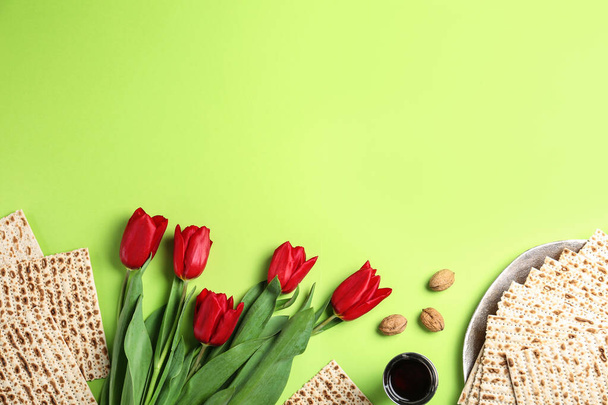 Flat lay composition with matzos on green background, space for text. Passover (Pesach) celebration - 写真・画像
