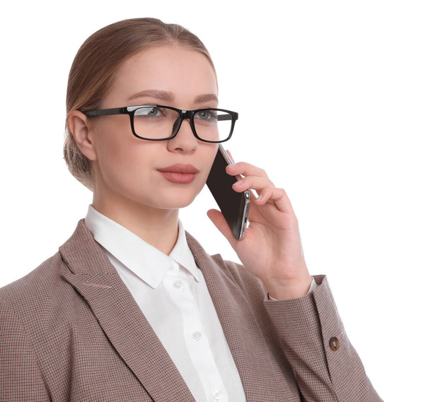 Young businesswoman talking on mobile phone against white background - Foto, Imagen