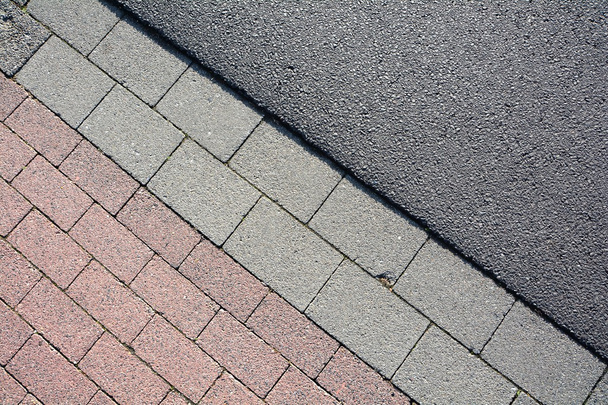 Asphalt and paving stones on a road - Photo, Image