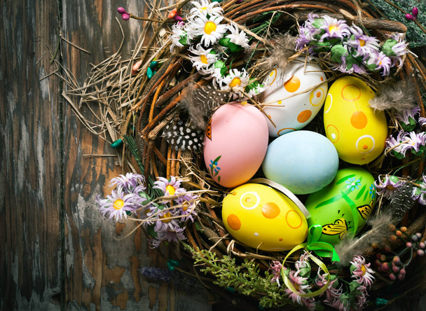 Happy Easter. Congratulatory easter background. Easter eggs and flowers. Background with copy space. Selective focus. Top view. - Photo, Image