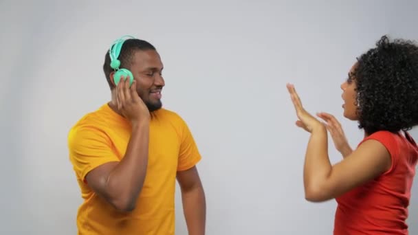 african american couple with headphones dancing - Кадри, відео