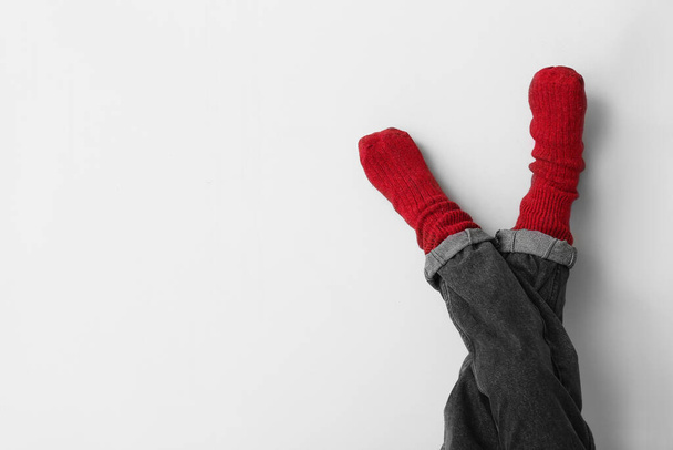 Legs of little child in socks and jeans on light background - Photo, Image