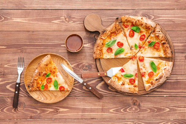 Composition with delicious pizza Margherita on wooden background - 写真・画像
