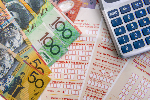 Australian dollars with calculator on tax form - Photo, Image