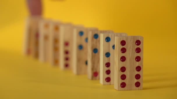 Slow motion of dominoes falling on yellow background - Footage, Video