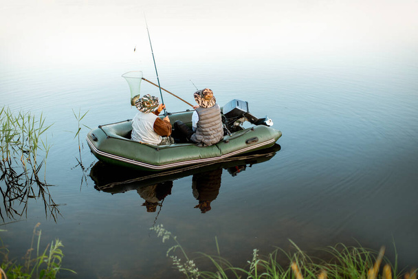 Grandfather with son fishing on the boat - 写真・画像