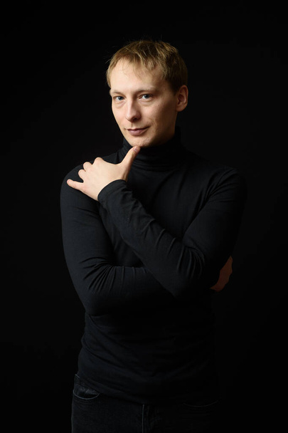 Portrait of determined goodlooking man wearing black clothes, black background. - Fotoğraf, Görsel